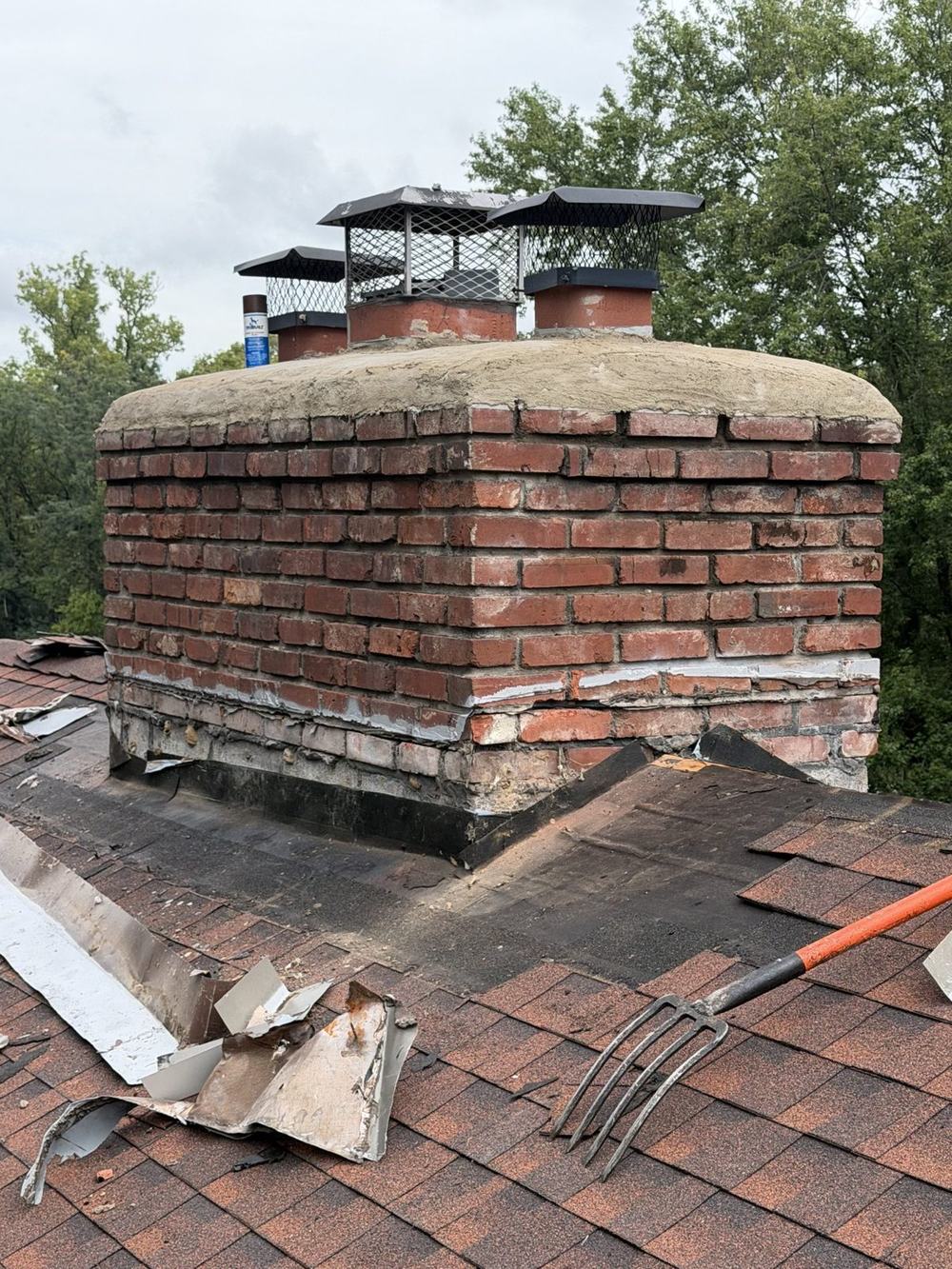 Chimney with old, worn flashing before the reflash