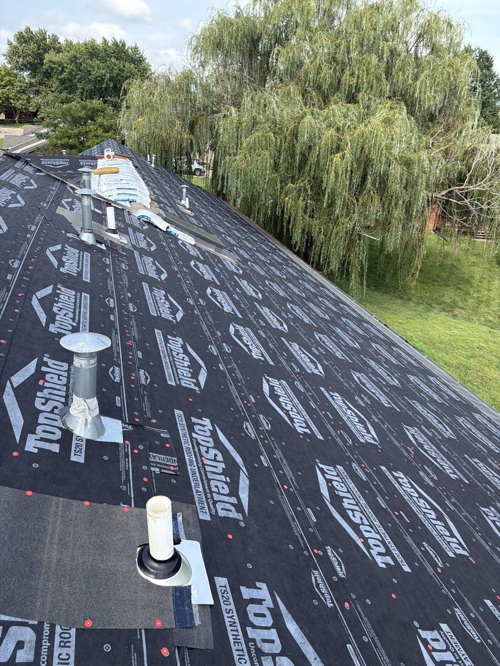 Roof deck covered in new synthetic underlayment during replacement