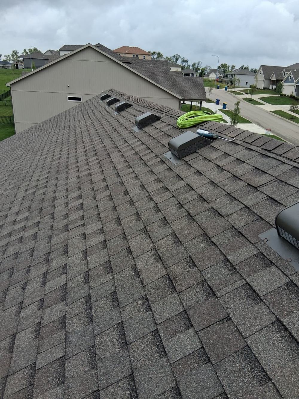 New asphalt shingles and roof vents on a home in a Kansas City subdivision